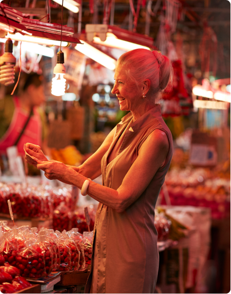 An older woman shops at an Asian market