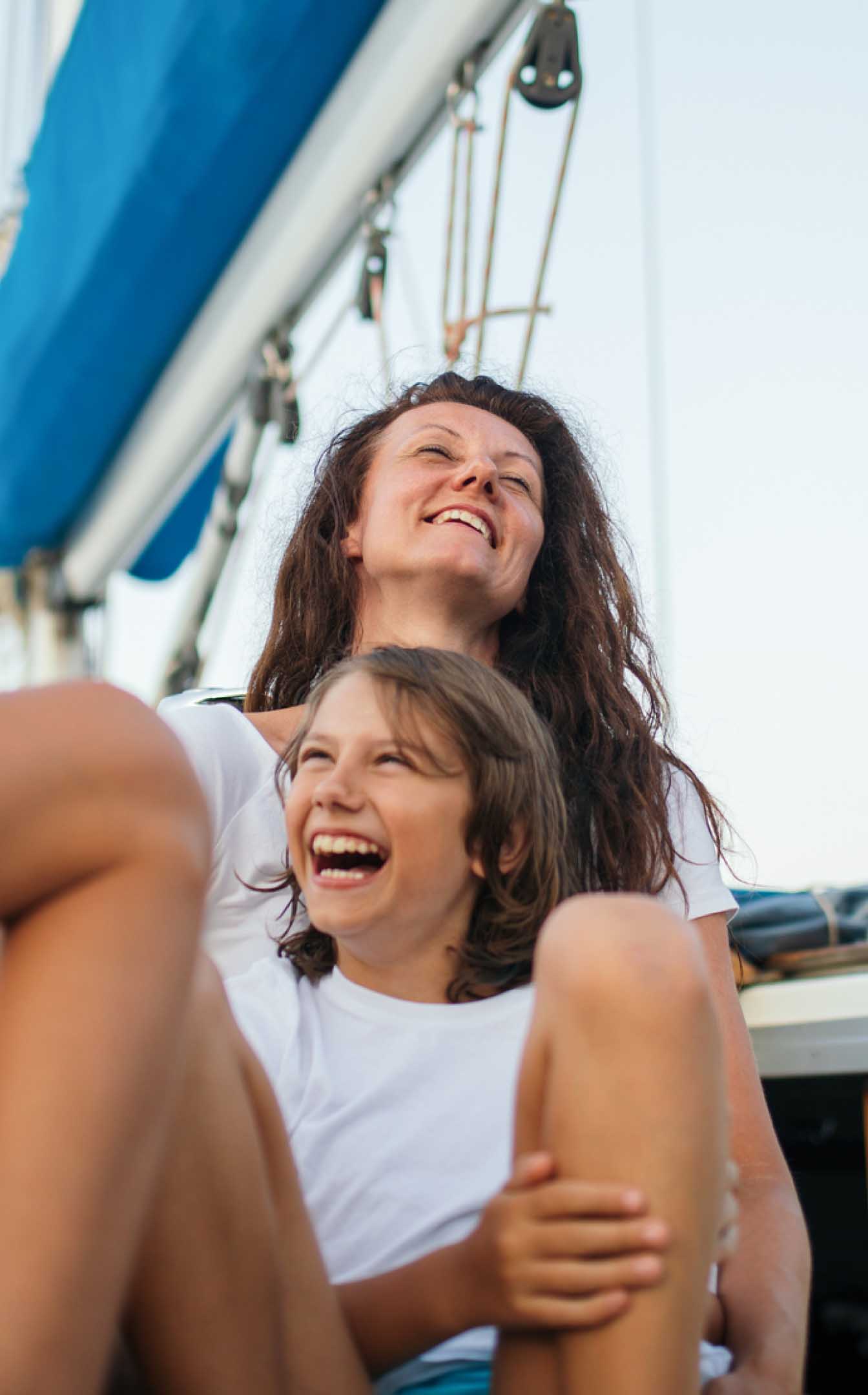 Mother and son laughing together on a boat