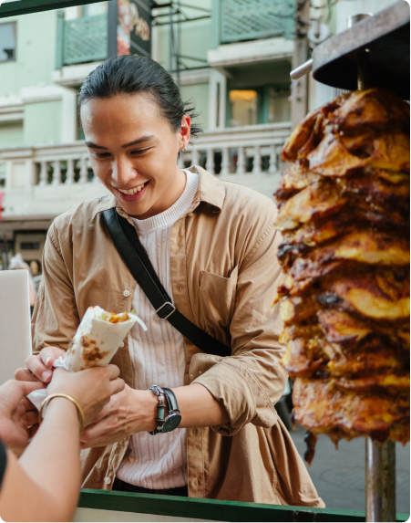 A man orders and receives a kebab