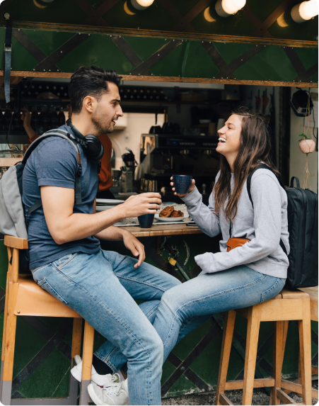 A couple enjoy a drink at an outdoor bar